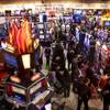 Attendees look over slot machines at the Bally booth during the Global Gaming Expo (G2E) at the Las Vegas Convention Center Tuesday, November 16, 2010.