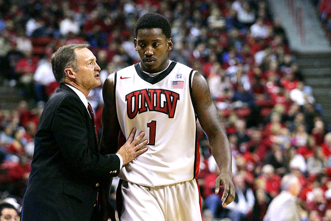 UNLV coach Lon Kruger talks to forward Quintrell Thomas after Thomas got into early foul trouble during Saturday's game against Wisconsin. UNLV upset 25th-ranked Wisconsin 68-65.