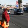 Officer Michael Lemley waits to cross Charleston Boulevard dressed in a turkey costume as part of an enforcement campaign Tuesday.