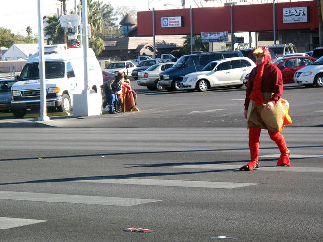 Officer Michael Lemley crosses Charleston Boulevard dressed in a turkey costume as part of an enforcement campaign Tuesday.