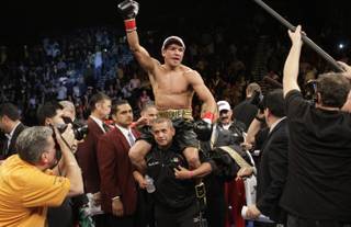 WBA/WBO lightweight champion Juan Manuel Marquez of Mexico celebrates his victory over Michael Katsidis of Australia during a title fight at the MGM Grand Garden Arena on November 27, 2010.