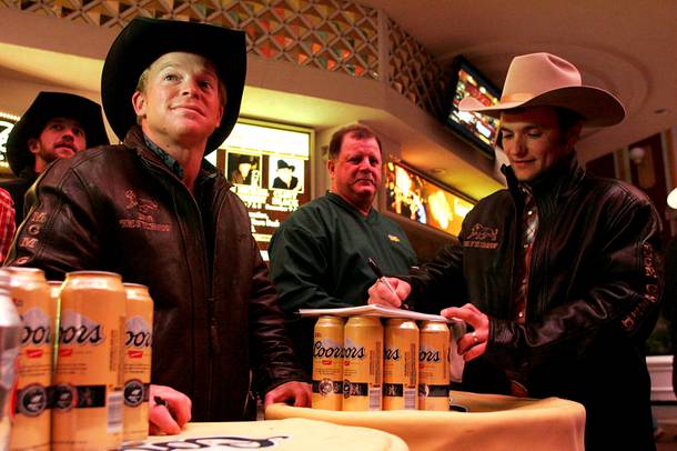 Bareback riders Wes Stevenson and Will Lowe sign autographs during the annual Downtown Hoedown at  Fremont Street Experience on Wednesday, Dec. 1, 2010.