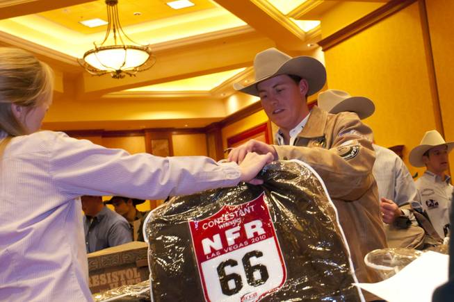 Steer wrestler Cody Cassidy receives a National Finals Rodeo jacket, ...