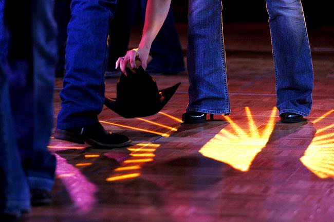 A dancer picks up a dropped cowboy hat during the Gold Coast's Buck AoN Ball Sunday, December 5, 2010.