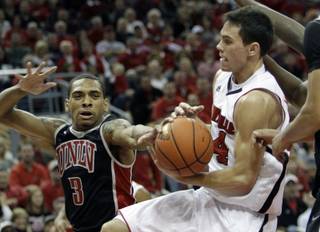 Louisville's Kyle Kuric, right, grabs a rebound away from UNLV's Anthony Marshall (3) in their NCAA college basketball game in Louisville, Ky., Saturday, Dec. 11, 2010. Kuric finished with 17 points and 5 rebounds as No. 24 Louisville beat No. 20 UNLV 77-69. 