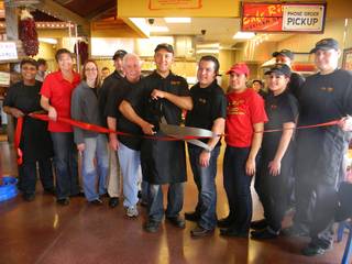 Ricky Gonalez, manager of Cafe Rio's new location on Blue Diamond Road, and his staff cut the red ribbon at the restaurant's grand opening on Wednesday, Dec. 15, 2010. Through Christmas, the restaurant is giving away a free meal to every 25th customer as it collects donations for the Children's Miracle Network of Southern Nevada.