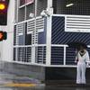 An Elvis impersonator waits to cross Casino Center Blvd. in downtown Las Vegas on a rainy Wednesday, Dec. Dec. 22, 2010. 