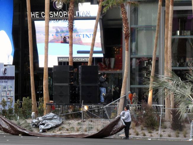 Workers clean up in front of the Cosmopolitan of Las Vegas on the Strip early on New Year's Day.