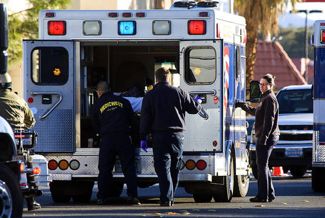 A person is loaded into an ambulance after an accident involving a school bus in the northbound lanes of Eastern Avenue between Tropicana and Harmon avenues, Jan. 10, 2011.