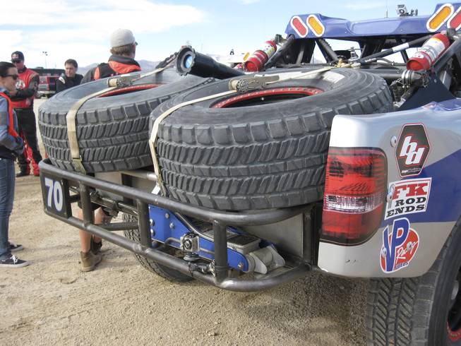 Most of the Trophy-Trucks carry spare tires.  Notice the floor jack strapped to the rear of the truck.