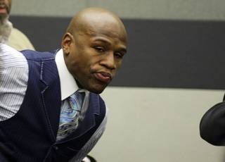 Boxer Floyd Mayweather Jr. rises as his name is called in Las Vegas Justice Court on Jan. 24, 2011. His preliminary hearing was continued until March 10.