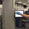 Transportation Security Administration supervisor Nick Fox, right, demonstrates new software being tested with advanced imaging technology at McCarran International Airport on Tuesday, Feb. 1, 2011. TSA spokesman Dwayne Baird says the software unveiled Tuesday lets passengers see what its security screeners see, and it uses a more generic image.