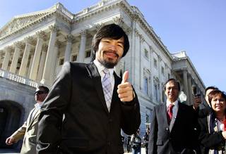 Boxing superstar and Filipino Congressman Manny Pacquiao poses in front of  the Senate Building on Capitol Hill after meeting with Senate Majority leader Harry Reid (D-NV) today in Washington D.C. as part of a goodwill tour February 15, 2011.