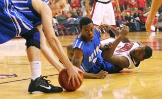 Air Force forward Tom Fow picks up a loose ball while Air Force guard Evan Washington and UNLV forward Quintrell Thomas are tangled up on the floor during the first half of Tuesday's game at the Thomas & Mack Center.