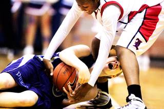 Cheryl Harless of Foothill, bottom, fights for the ball with Liberty's Alena Evans during the Sunrise Regional girls basketball championships at Foothill High School in Henderson Friday, February 18, 2011.