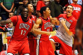 UNLV players Brice Massamba, Chace Stanback, Justin Hawkins and Karam Mashour celebrate taking the lead late against New Mexico during Wednesday's Mountain West Conference game at The Pit in Albuquerque. UNLV won 77-74 in overtime.