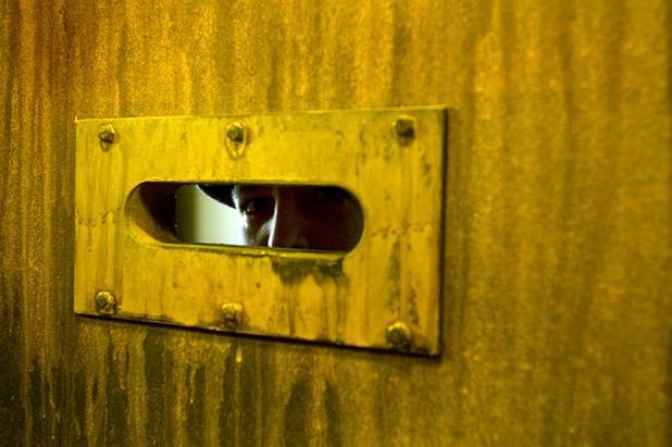 A prohibition-era "gangster" peers through the door of a warehouse in the back of a speakeasy during a preview of the Las Vegas Mob Experience at the Tropicana Tuesday, March 1, 2011. The $25 million Mob Experience will officially open March 29.