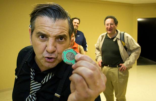 A "gangster" (played by actor Joey Ciccone) glares at the camera as tourist George Salamy of New York looks on during a preview of the Mob Experience at the Tropicana Tuesday, March 1, 2011. The $25 million Mob Experience will officially open March 29.