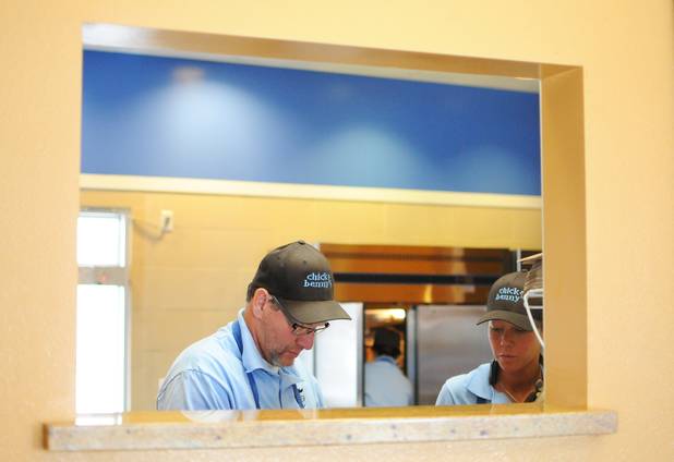 Owner Mark Goldenberg and his daughter Nicci cook up chicken tenders and French beignets at their new Henderson restaurant, Chick and Benny's, on Tuesday, March 1, 2011. 