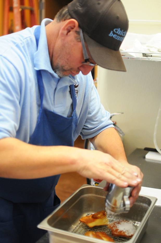 Co-owner Mark Goldenberg shakes powdered sugar over French beignets in the kitchen of his new Henderson eatery, Chick and Benny's, on Tuesday, March 1, 2011.  