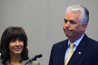 U.S. Sen. John Ensign announces he will not seek another term in 2012 during a news conference at the Lloyd George Federal Building in Las Vegas on Monday, March 7, 2011. Ensign's wife, Darlene, stands by him at left.