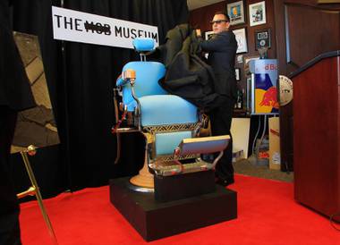 Artie Nash unveils the Mob Museum’s most recent acquisition, the barber chair that Albert Anastasia was murdered in Wednesday, March 9, 2011.