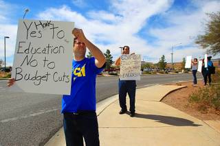 College of Southern Nevada students Justin McAffee, left, and Isaac Shalom protest proposed budget cuts Tuesday, March 15, 2011 at CSN's Henderson campus.