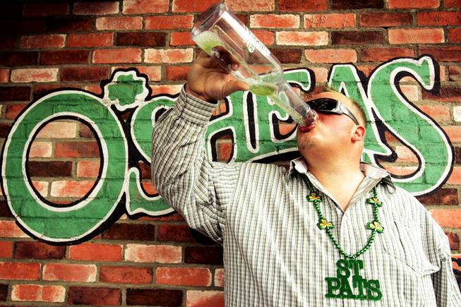 Wyatt Kykamp of Denver finishes off a green beer outside of O'Sheas Casino in Las Vegas during St. Patrick's Day Thursday, March 17, 2011.