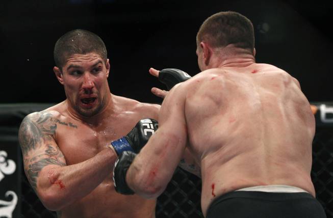 Brendan Schaub, left, and Mirko Cro Cop trade punches during their mixed martial arts match at UFC 128  Saturday, March 19, 2011, in Newark, N.J. Schaub won by KO.