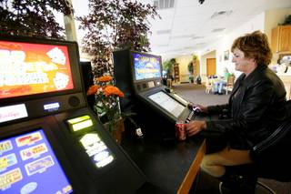 Cindy Clark plays a slot machine at Dotty's near Eastern and Serene in Henderson on Thursday, March 24, 2011.