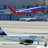 A Southwest jet takes off as Mexican airline Volaris makes its inaugural arrival at McCarran International Airport Wednesday, March 30, 2011.
