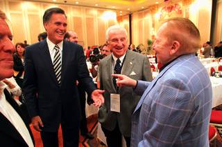 Former Massachusetts Gov. Mitt Romney talks to Sheldon Adelson after addressing a meeting of the Republican Jewish Coalition, April 2, 2011.