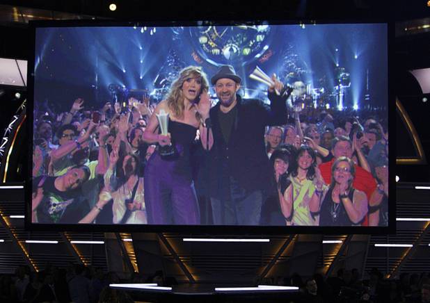 A video screen shows singers Jennifer Nettles, left, and Kristian Bush of Sugarland accepting the Vocal Duo Group of the Year award from the Mandalay Bay during the 46th annual Academy of Country Music Awards at the MGM Grand Garden Arena April 3, 2011