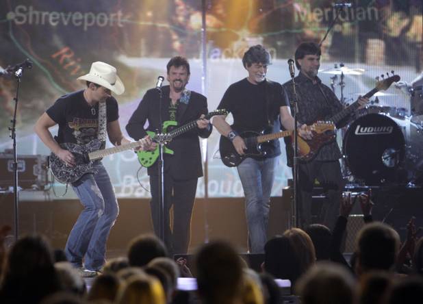 Brad Paisley, far left, performs with members of the band Alabama (left to right) Jeff Cook, Randy Owen and Teddy Gentry during the 46th annual Academy of Country Music Awards at the MGM Grand Garden Arena Sunday, April 3, 2011. 