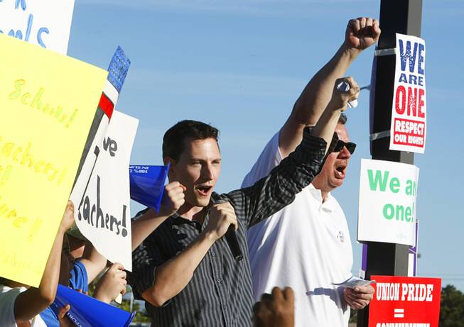 J.T. Creedon, center, College of Southern Nevada student body president, speaks during a rally protesting proposed budget cuts to education at the CSN, Charleston campus Monday, April 4, 2011.  Randy Soltero. a member of the Sheet Metal Workers union, Local 88, is at right.