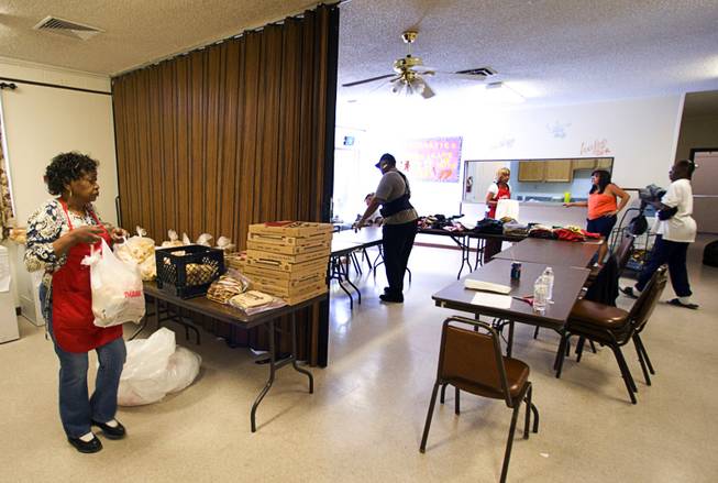Volunteer Sophia White, left, makes a food bag at the Calvary Southern Baptist Church in North Las Vegas Wednesday, April 27, 2011. The Fish Inc. program provides emergency food assistance to people who are struggling to get by.