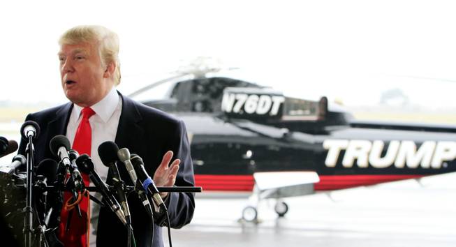 Donald Trump, a possible 2012 presidential candidate, talks with reporters  at the Pease International Tradeport on Wednesday, April 27, 2011, in Portsmouth, N.H.