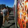 Tourists walk past an advertisement for "Peepshow" on the Las Vegas Strip in this April 28, 2011, file photo. 
