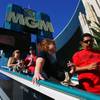 Tourists ride an escalator down from a pedestrian overpass Thursday, April 28, 2011, on the Strip.
