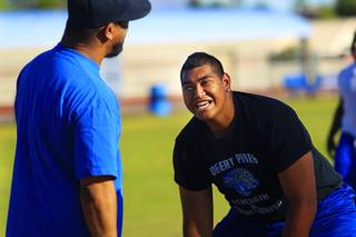 Desert Pines lineman Cedrick Poutasi laughs at one of his coaches during practice Wednesday, May 11, 2011.