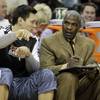 In this Jan. 20, 2011 photo, Charlotte Bobcats assistant coach Charles Oakley, right, talks with Eduardo Najera, left, in the first half of an NBA basketball game against the Philadelphia 76ers in Charlotte, N.C.  