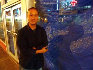 Tony Hsieh stands next to one of the empty storefronts on East Fremont Street. While the area is beginning to see signs of a business life, dozens of Hsieh's employees at Zappos.com are working on visions to bring music, education, restaurants and other cultural amenities to the area, hopefully by the time the company moves its headquarters and 1,200 workers into City Hall in 2013.