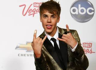 Justin Bieber poses backstage after winning the award for Top New Artist during the Billboard Music Awards at MGM Grand Garden Arena on Sunday, May 22, 2011.