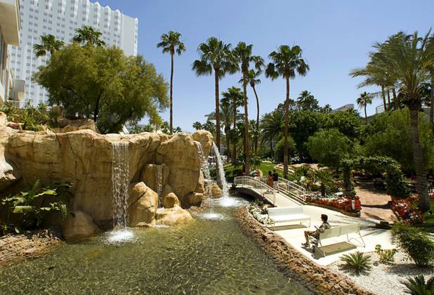 A guest relaxes with an electronic book by a waterfall at the Tropicana Tuesday, May 24, 2011.