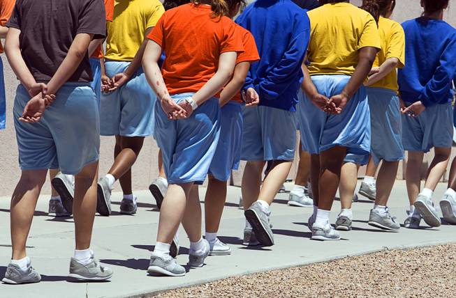 Juveniles hold their hands behind their backs as they walk through the Clark County Juvenile Detention Center on Wednesday, May 25, 2011.