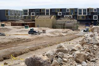 Model homes are shown under construction at a residential development site near Horizon Ridge Parkway and Gibson Road in Henderson Wednesday, June 1, 2011. The defunct Vantage Lofts project is in the background.
