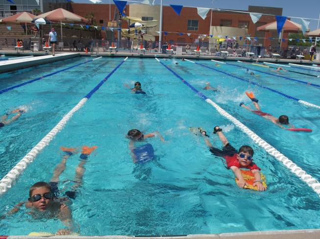 Swimmers paddle their way across the pool at the Henderson Multigenerational Center Tuesday morning. The children were part of an international attempt to set the record for the world's largest swim lesson.