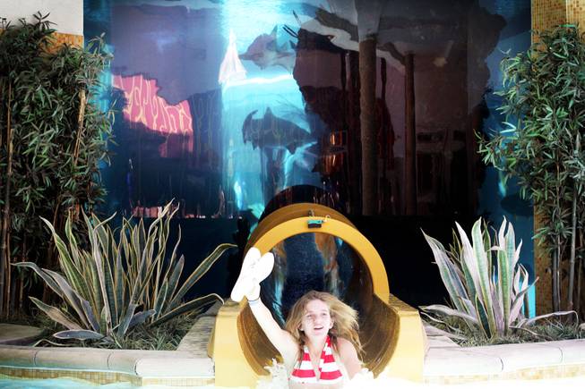 Lindsey Sokolowski, 11, of Las Vegas rides the slide that runs through the shark tank at the pool at the Golden Nugget in downtown Las Vegas Friday, June 17, 2011