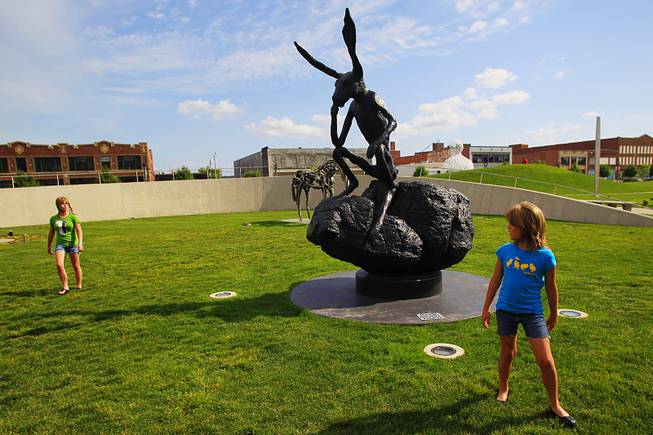 Rowan and Aria Morris check out the sculptures in the Poppajohn Sculpture Park in downtown Des Moines.