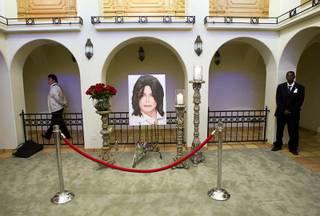 A photo of Michael Jackson is displayed at a home where the entertainer used to live on Palomino Lane Saturday, June 25, 2011. The homeowner opened a portion of the home to the public to mark the second anniversary of the entertainer's death.